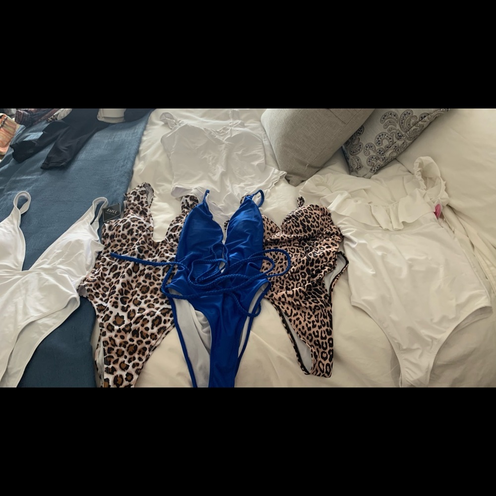 Set of 9 one piece bathing suits and 1 bikini.